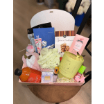 Gift basket with candles, body care items, cookies, and a towel