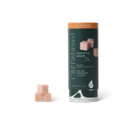 Cocktail mixer cubes in a cylindrical container with three cubes beside it