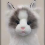 Fluffy cat-faced plush toy with white and gray fur