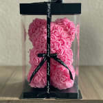 Pink rose teddy bear in a clear gift box with a black ribbon