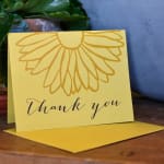 Yellow thank-you card with a flower outline and matching envelope