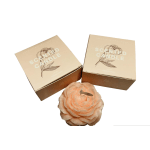 Two boxed scented candles and a peach flower-shaped candle