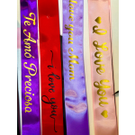 Four satin ribbons with gold lettering and hearts hang vertically.
