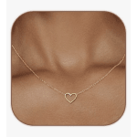 Gold heart pendant necklace on a model's neck