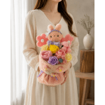 Woman holding a pastel bouquet with a plush bunny and roses
