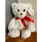 White teddy bear with a red ribbon and hanging tag