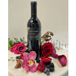 Wine bottle surrounded by roses, orchid petals, and berries