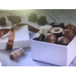 Box of assorted chocolates with a ribbon on a table