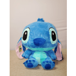 Blue plush Stitch toy with large ears sitting upright