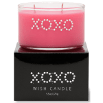 Pink candle in a glass jar on a black box