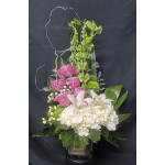 Tall floral arrangement with pink and white blooms in a glass vase