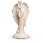 Beige angel figurine with folded wings on a round base