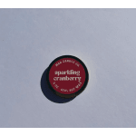 Round tin candle labeled sparkling cranberry