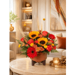Bright mixed flower arrangement in a low brown container