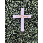 Pink cross sign with "In Memory" text against a leafy backdrop