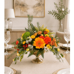 Bright orange and yellow floral centerpiece in a gold pedestal vase