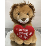 Plush lion holding a red heart with embroidered text