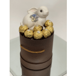 White ceramic rabbit topper on a box of gold-wrapped chocolates
