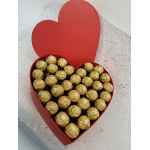 Heart-shaped red box filled with gold-wrapped chocolates