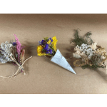 Three small dried flower bouquets on brown paper