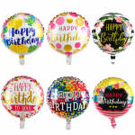 Six round birthday balloons with colorful printed designs