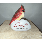 Decorative cardinal figurine on a stone with the words "Love Lives Forever"