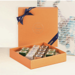 Orange gift box with assorted chocolates tied with a navy ribbon