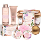 Cherry blossom themed pink bath gift set with bottles, jars, loofah, and a gold bath bomb.