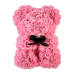 Pink rose-covered teddy bear with a black ribbon bow at the neck