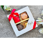 Box of assorted chocolates tied with a red ribbon