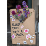 Dried purple and pink flowers wrapped in brown paper with handwritten text