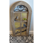 Decorative wooden window frame with bird illustrations