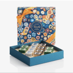 Box of assorted chocolates in a patterned gift box with an orange ribbon