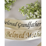 Cream memorial ribbons with white flowers and the words Beloved Grandfather and Beloved Mother