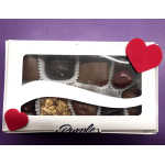 Box of assorted chocolates with red heart decorations