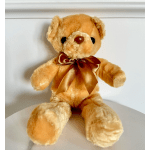 Tan teddy bear with a brown ribbon bow