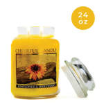 Yellow candle jar labeled sunflower and driftwood with a lid beside it