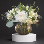 White chrysanthemum and alstroemeria arrangement in a round glass vase