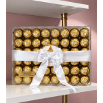 Box of gold-wrapped chocolates tied with a white ribbon and bow