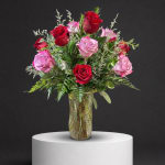 Bouquet of red and pink roses in a glass vase