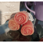 Three spiral pink-and-cream candles wrapped in mesh