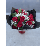 Bouquet of red roses with white baby's breath in black wrap