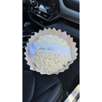 Cream rose bouquet with a Happy Birthday ribbon in a car seat