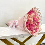 Pink and peach rose bouquet wrapped in pale pink paper