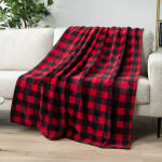 Red and black plaid blanket draped over a light sofa