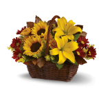 Basket arrangement with yellow lilies, sunflowers, and red daisies