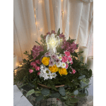 Mixed flower arrangement with roses, daisies, and an angel figurine