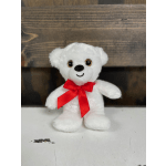 White plush teddy bear with a red ribbon bow