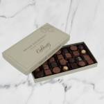 Open box of assorted chocolates on a light surface