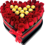 Heart-shaped box filled with red roses and gold-wrapped chocolates